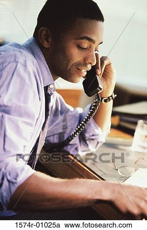 Businessman talking on a telephone View Large Photo Image Stock Image - Businessman talking on a telephone. Fotosearch