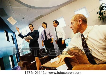 Businesswoman throwing documents with three businessmen watching View Large Photo Image Stock Image - Businesswoman throwing documents with three businessmen watching. Fotosearch