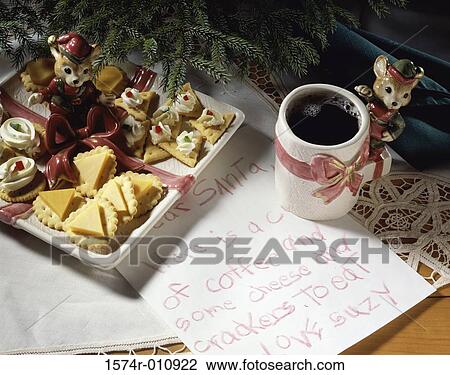 Stock Image - Cheese on crackers and a cup of coffee with a letter to Santa Claus. Fotosearch