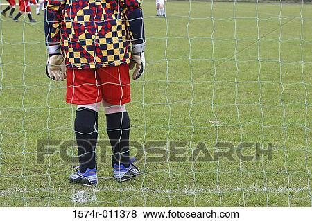 Stock Photo - Children playing soccer. Fotosearch