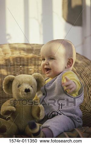 Close-up of a baby boy playing with a teddy bear View Large Photo Image Stock Image - Close-up of a baby boy playing with a teddy bear. Fotosearch