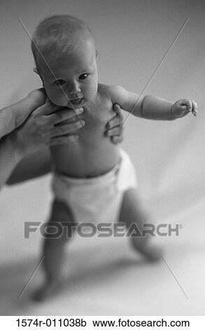 Close-up of a baby in a person's hands View Large Photo Image Stock Image - Close-up of a baby in a person's hands. Fotosearch