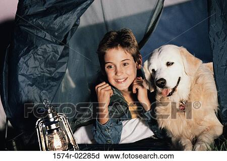 Close-up of a boy camping in a tent with his dog View Large Photo Image Stock Image - Close-up of a boy camping in a tent with his dog. Fotosearch