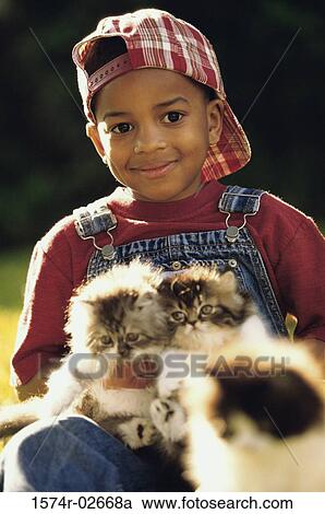 Close-up of a boy holding cats View Large Photo Image Stock Image - Close-up of a boy holding cats. Fotosearch