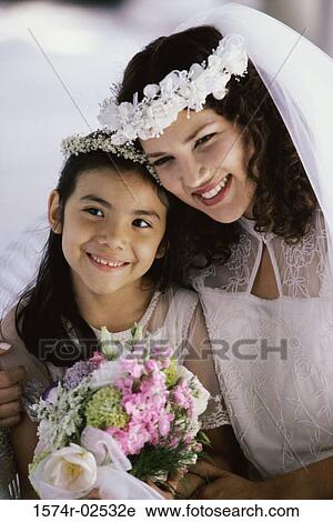 Close-up of a bride smiling with a flower girl View Large Photo Image Stock Image - Close-up of a bride smiling with a flower girl. Fotosearch
