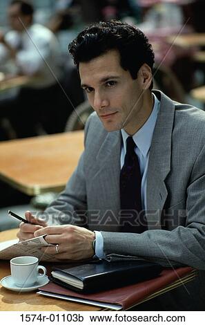 Close-up of a businessman sitting View Large Photo Image Stock Image - Close-up of a businessman sitting. Fotosearch