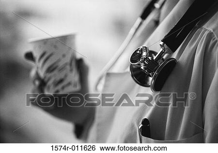 Close-up of a doctor holding a disposable cup View Large Photo Image Stock Photograph - Close-up of a doctor holding a disposable cup. Fotosearch