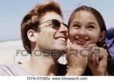Close-up of a father and his daughter smiling View Large Photo Image Stock Image - Close-up of a father and his daughter smiling. Fotosearch