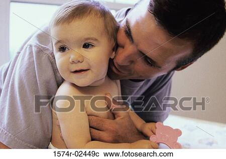 Close-up of a father holding his baby boy View Large Photo Image Stock Image - Close-up of a father holding his baby boy. Fotosearch