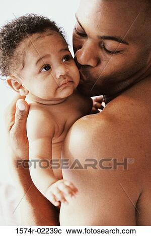 Close-up of a father kissing his baby boy View Large Photo Image Stock Image - Close-up of a father kissing his baby boy. Fotosearch