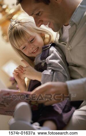 Close-up of a father reading to his daughter View Large Photo Image Stock Image - Close-up of a father reading to his daughter. Fotosearch