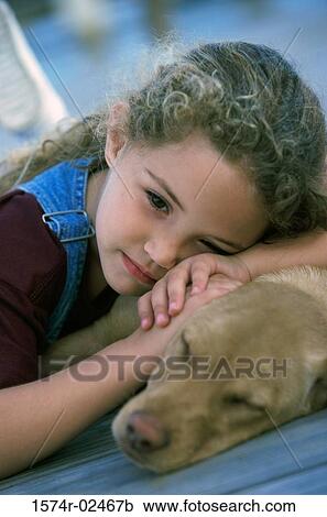 Close-up of a girl lying with her dog View Large Photo Image Stock Image - Close-up of a girl lying with her dog. Fotosearch
