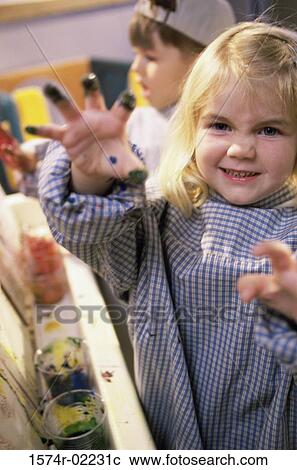 Stock Image - Close-up of a girl with paint on her hand. Fotosearch