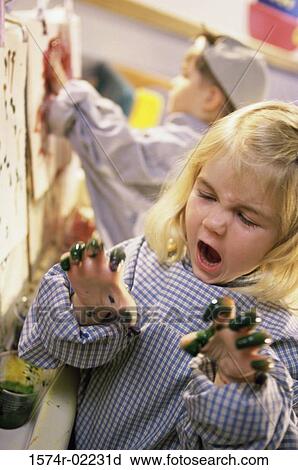 Close-up of a girl with paint on her hand View Large Photo Image Stock Image - Close-up of a girl with paint on her hand. Fotosearch