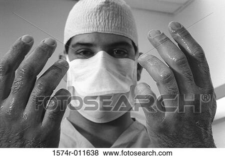 Close-up of a male surgeon holding up his washed hands View Large Photo Image Stock Photo - Close-up of a male surgeon holding up his washed hands. Fotosearch