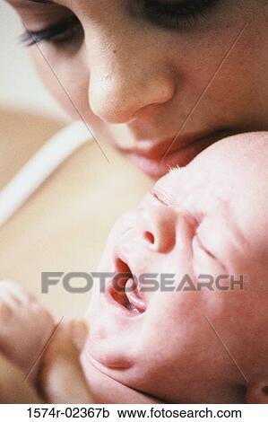 Close-up of a mother carrying her baby boy View Large Photo Image Stock Image - Close-up of a mother carrying her baby boy. Fotosearch