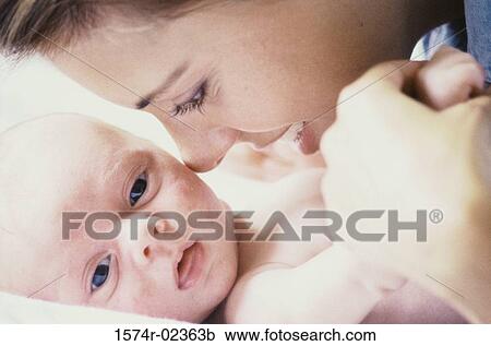 Stock Image - Close-up of a mother holding her baby boy. Fotosearch