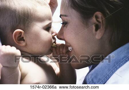 Stock Image - Close-up of a mother holding her baby boy. Fotosearch
