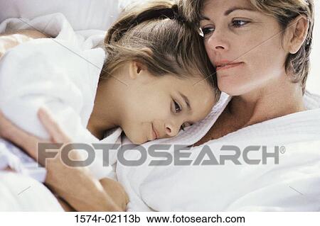 Close-up of a mother lying down with her daughter View Large Photo Image Stock Image - Close-up of a mother lying down with her daughter. Fotosearch