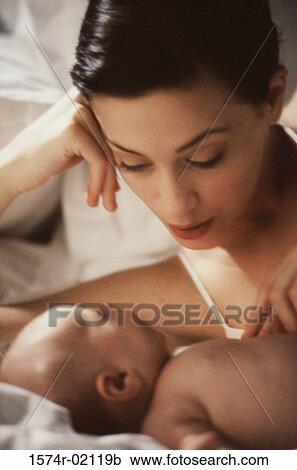 Close-up of a mother lying with her baby boy View Large Photo Image Stock Image - Close-up of a mother lying with her baby boy. Fotosearch