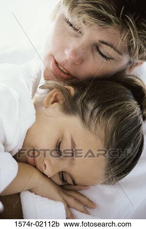 Stock Image - Close-up of a mother sleeping with her daughter. Fotosearch