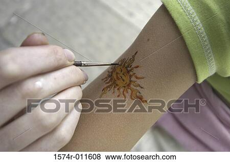 Close-up of a person painting on an arm View Large Photo Image Stock Photo - Close-up of a person painting on an arm. Fotosearch