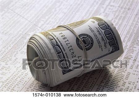 Close-up of a roll of American dollar bills on stock listings View Large Photo Image Stock Photo - Close-up of a roll of American dollar bills on stock listings. Fotosearch