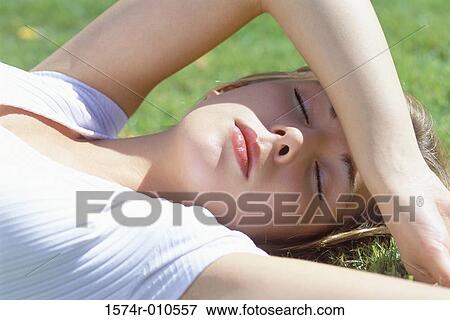 Close-up of a teenage girl sleeping on a lawn View Large Photo Image Stock Photo - Close-up of a teenage girl sleeping on a lawn. Fotosearch