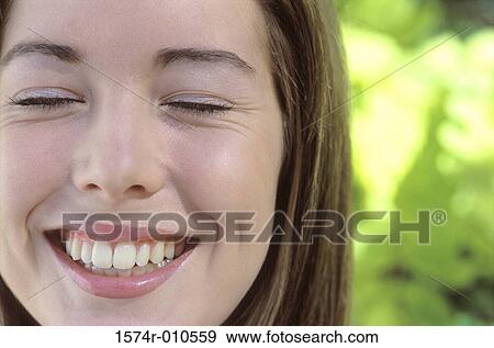 Close-up of a teenage girl smiling View Large Photo Image Stock Photo - Close-up of a teenage girl smiling. Fotosearch
