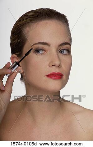 Close-up of a woman applying mascara View Large Photo Image Stock Image - Close-up of a woman applying mascara. Fotosearch