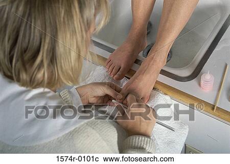 Close-up of a woman doing a pedicure View Large Photo Image Stock Image - Close-up of a woman doing a pedicure. Fotosearch