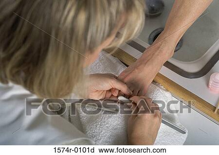 Close-up of a woman doing a pedicure View Large Photo Image Stock Image - Close-up of a woman doing a pedicure. Fotosearch
