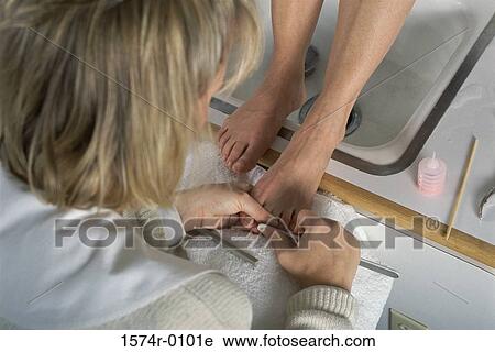 Stock Image - Close-up of a woman doing a pedicure. Fotosearch