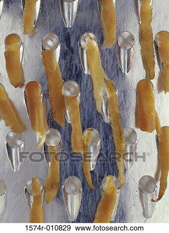 Close-up of cheese being grated View Large Photo Image Stock Photo - Close-up of cheese being grated. Fotosearch