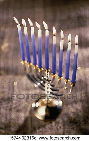 Stock Image - Close-up of lit candles on a menorah. Fotosearch