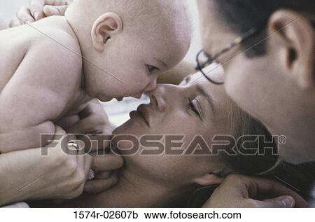 Close-up of parents playing with their baby boy View Large Photo Image Stock Image - Close-up of parents playing with their baby boy. Fotosearch