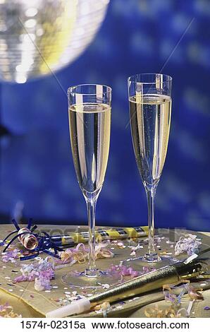 Close-up of two champagne flutes on a table View Large Photo Image Stock Image - Close-up of two champagne flutes on a table. Fotosearch
