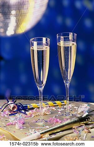 Close-up of two champagne flutes on a table View Large Photo Image Stock Image - Close-up of two champagne flutes on a table. Fotosearch