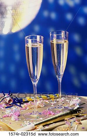 Close-up of two champagne flutes on a table View Large Photo Image Stock Image - Close-up of two champagne flutes on a table. Fotosearch