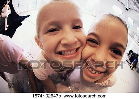 Close-up of two girls smiling View Large Photo Image Stock Image - Close-up of two girls smiling. Fotosearch