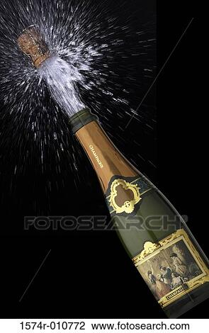 Stock Image - Cork popping out of champagne bottle. Fotosearch