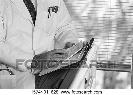 Doctor writing a prescription View Large Photo Image Stock Photo - Doctor writing a prescription. Fotosearch