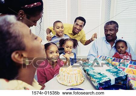 Stock Image - Family at a birthday party. Fotosearch