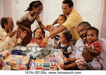 Stock Image - Family celebrating a birthday party. Fotosearch