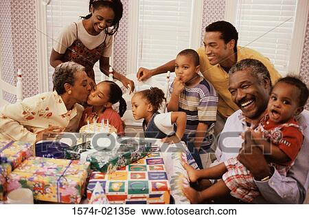 Stock Image - Family celebrating a birthday party. Fotosearch