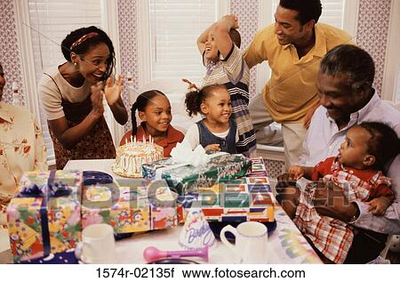 Stock Image - Family celebrating a birthday party. Fotosearch