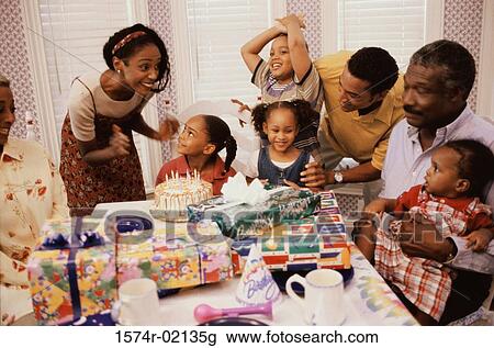 Stock Image - Family celebrating a birthday party. Fotosearch