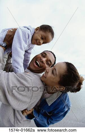 Father and mother together with their daughter at the beach View Large Photo Image Stock Image - Father and mother together with their daughter at the beach. Fotosearch