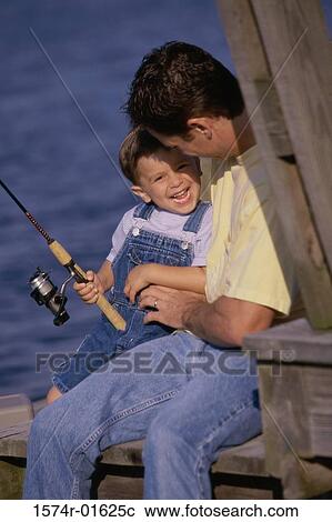 Stock Image - Father and son fishing from a dock. Fotosearch