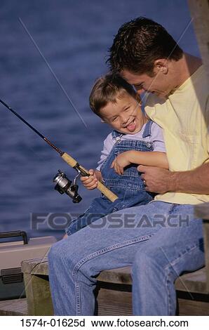 Stock Image - Father and son fishing from a dock. Fotosearch